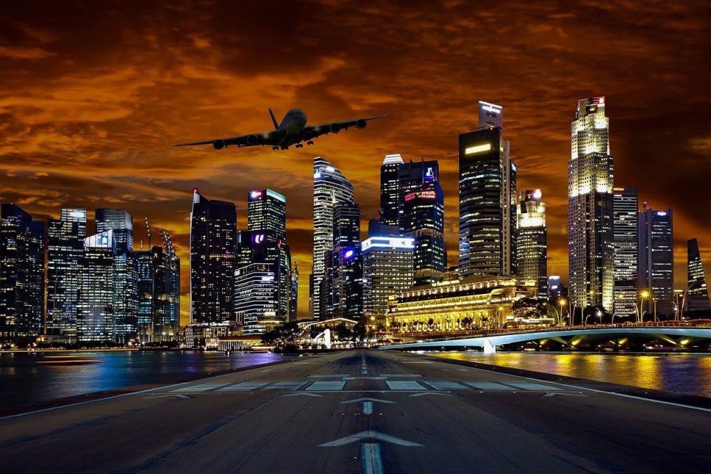 Plane flying above the Singapore city skyline